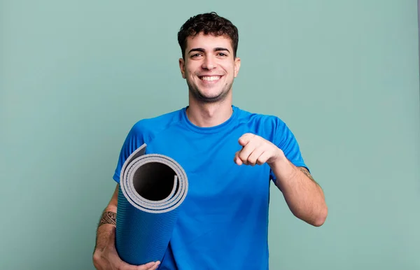 adult man pointing at camera choosing you. fitness and yoga concept