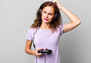 hispanic pretty woman smiling happily and daydreaming or doubting. gamer concept