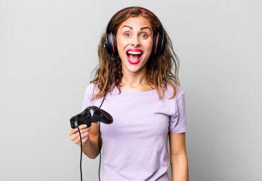 hispanic pretty woman looking happy and pleasantly surprised. gamer concept