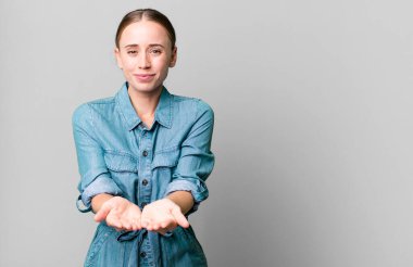 caucasian pretty woman smiling happily with friendly and  offering and showing a concept