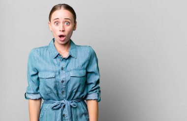 caucasian pretty woman looking very shocked or surprised