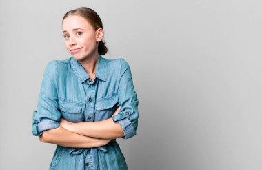 caucasian pretty woman shrugging, feeling confused and uncertain