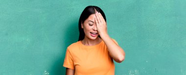 Güzel Latin bir kadın gülüyor ve alnına şaplak atıyor. Unuttum ya da aptalca bir hataydı. 