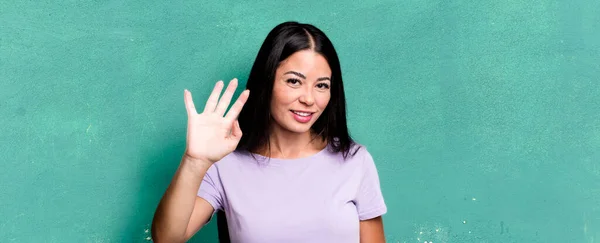Pretty Latin Woman Smiling Happily Cheerfully Waving Hand Welcoming Greeting — Stock Photo, Image