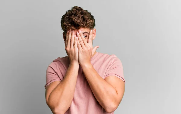 Young Adult Caucasian Man Covering Face Hands Peeking Fingers Surprised — Stockfoto