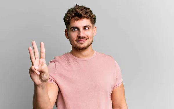 Young Adult Caucasian Man Smiling Looking Friendly Showing Number Three — Foto de Stock