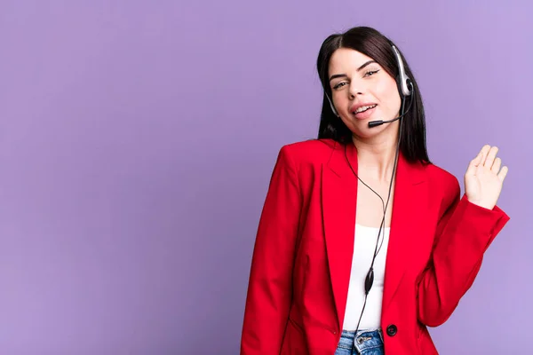 smiling happily, waving hand, welcoming and greeting you. telemarketer with a headset concept