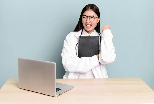 若い大人の可愛いアジア系医師の女性がノートパソコンを持った机の上で — ストック写真
