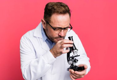 Orta yaşlı bir adam. Futbol topuyla bilim adamı konsepti spor koçu konsepti