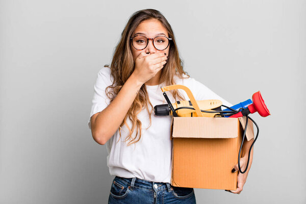 hispanic pretty woman covering mouth with hands with a shocked