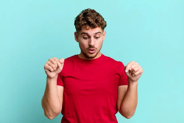 Young Adult Caucasian Man Open Mouth Pointing Downwards Both Hands — Stock Photo, Image