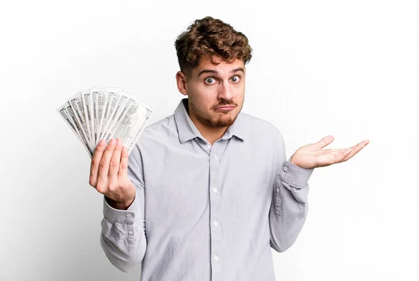 Young Adult Caucasian Man Feeling Puzzled Confused Doubting Dollar Bank — Foto Stock