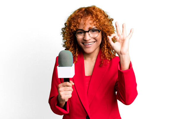 Рыжие волосы красивая женщина чувствует себя счастливой, показывая одобрение с нормальным жестом. журналист и ведущий концепции