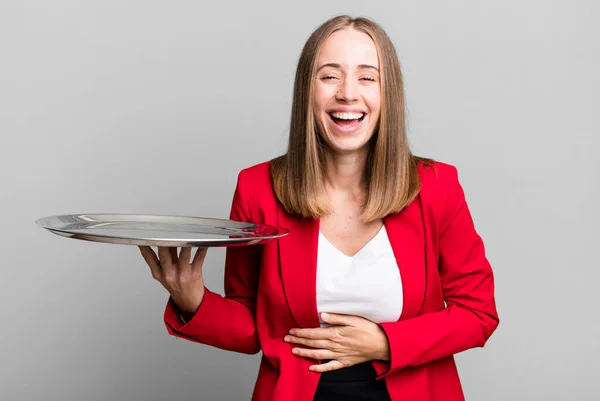 laughing out loud at some hilarious joke. businesswoman presenting with a tray