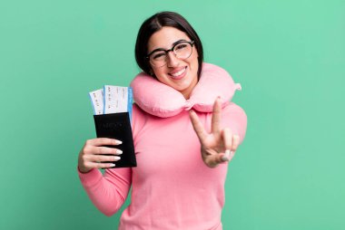 smiling and looking happy, gesturing victory or peace. flight passenger concept
