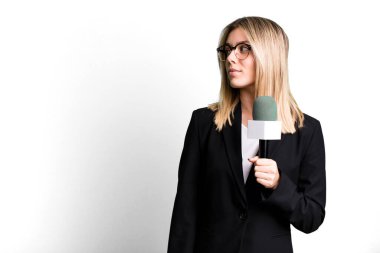 young pretty journalist or presenter woman with a microphone
