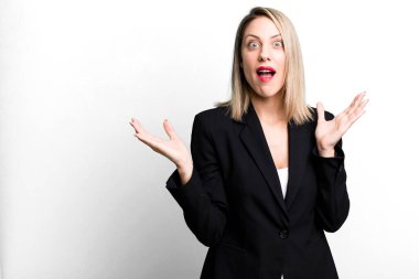 pretty blonde woman feeling happy and astonished at something unbelievable. businesswoman concept