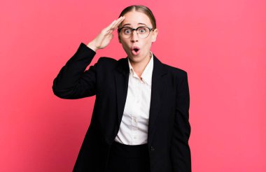 caucasian pretty woman looking happy, astonished and surprised. business concept