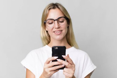 pretty caucasian blonde woman using her smartphone