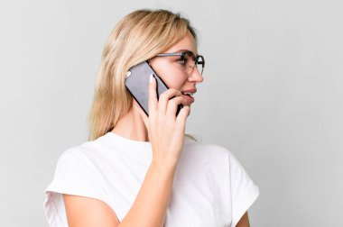 pretty caucasian blonde woman using her smartphone