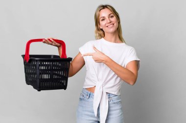 pretty caucasian woman with an empty shopping basket