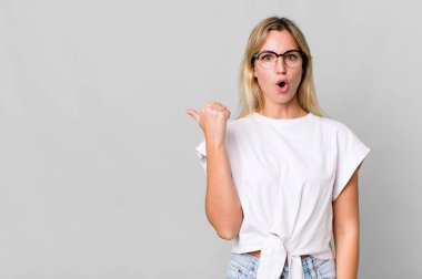 caucasian blonde woman looking astonished in disbelief. copy space concept