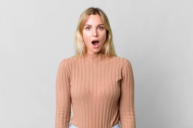 caucasian blonde woman looking very shocked or surprised