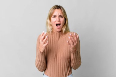 caucasian blonde woman looking desperate, frustrated and stressed