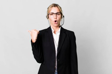 caucasian blonde woman looking astonished in disbelief. telemarketing cocnept