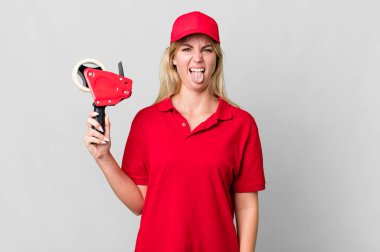 caucasian blonde woman feeling disgusted and irritated and tongue out. shipping packer concept
