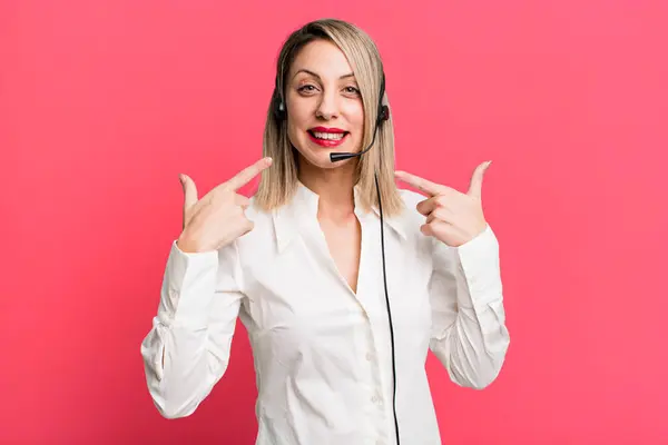 Pretty Blonde Woman Smiling Confidently Pointing Own Broad Smile Telemarketer — Foto de Stock