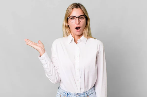 Caucasian Blonde Woman Looking Surprised Shocked Jaw Dropped Holding Object — 图库照片