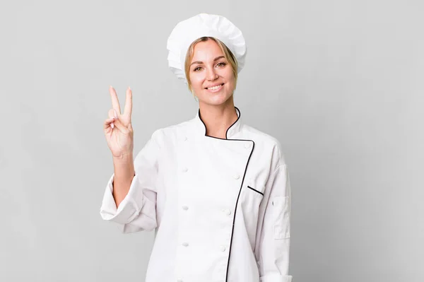 Caucasian Blonde Woman Smiling Looking Friendly Showing Number Two Chef — Zdjęcie stockowe