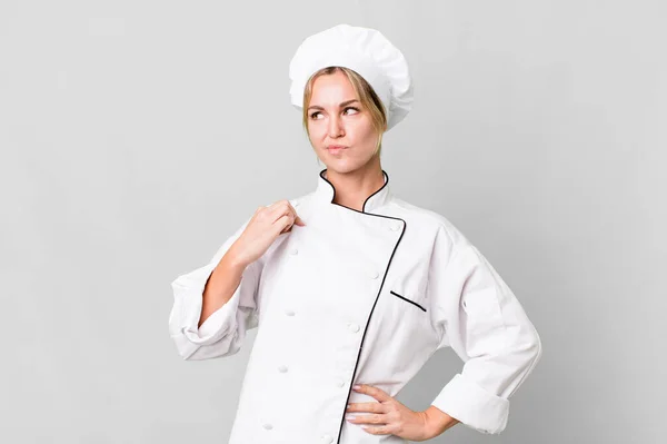 caucasian blonde woman looking arrogant, successful, positive and proud. chef concept