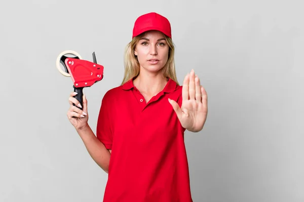 Caucasian Blonde Woman Looking Serious Showing Open Palm Making Stop — Zdjęcie stockowe