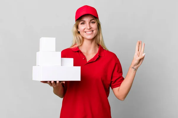 Caucasian Blonde Woman Smiling Looking Friendly Showing Number Three Delivery — Stockfoto