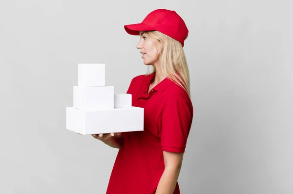Caucasian Blonde Woman Profile View Thinking Imagining Daydreaming Delivery Boxes — Stok fotoğraf