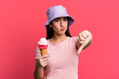 feeling cross,showing thumbs down. ice cream and summer concept