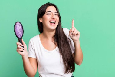 feeling like a happy and excited genius after realizing an idea. hair comb concept