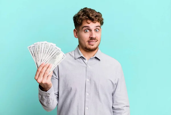Young Adult Caucasian Man Looking Puzzled Confused Dollar Bank Notes — Foto Stock