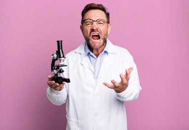 Orta yaşlı bir adam sinirli, sinirli ve sinirli görünüyor. Bilim adamı konsepti