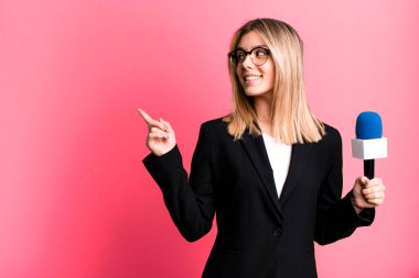 young pretty journalist or presenter woman with a microphone