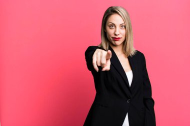 pretty blonde woman pointing at camera choosing you. businesswoman concept