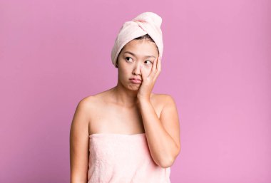 pretty asian woman feeling bored, frustrated and sleepy after a tiresome. beauty and shower concept clipart