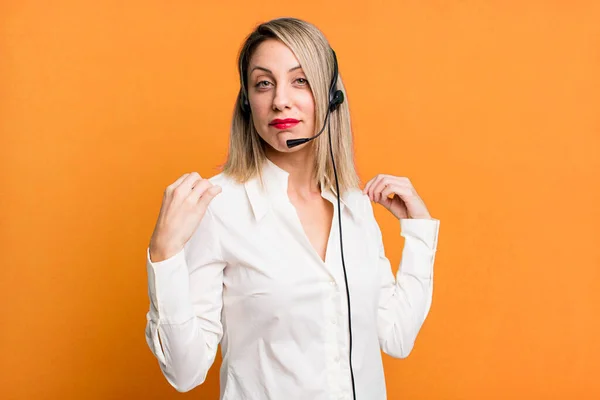 pretty blonde woman looking arrogant, successful, positive and proud. telemarketer concept