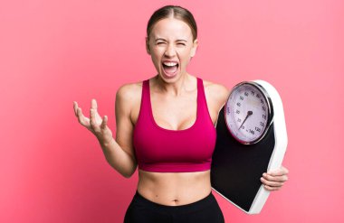 caucasian pretty woman looking angry, annoyed and frustrated. fitness and diet concept