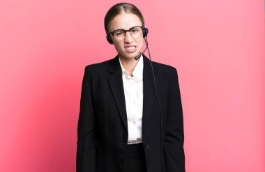 caucasian pretty woman feeling puzzled and confused. telemarketing concept