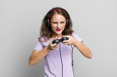 hispanic pretty young woman playing with headphones and a control. gamer concept