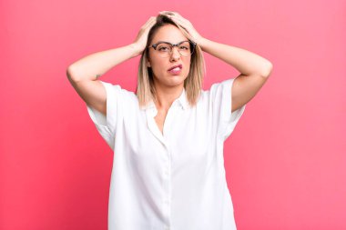 blonde adult woman feeling frustrated and annoyed, sick and tired of failure, fed-up with dull, boring tasks
