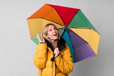pretty caucasian woman with a umbrella and an anorak